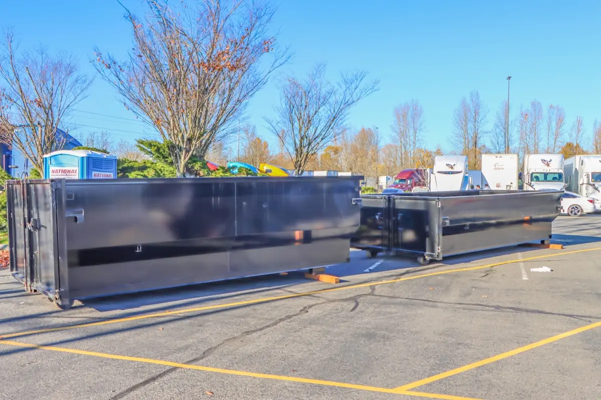 Professional dumpster rental service with roll-off container on residential driveway in Mason